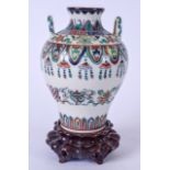 A TWIN HANDLED CHINESE DOUCAI PORCELAIN VASE BEARING QIANLONG MARKS, decorated with foliage and