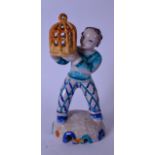A RARE AUSTRIAN GMUNDNER KERAMIK POTTERY FIGURINE, in the form of a standing figure holding a bird