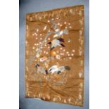 A 19TH CENTURY JAPANESE MEIJI PERIOD EMBROIDERED SILK PANEL depicting birds in flight over foliage