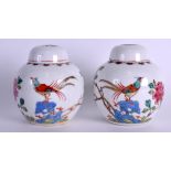 A PAIR OF CHINESE FAMILLE ROSE GINGER JARS AND COVERS painted with birds and floral sprays. 11.5