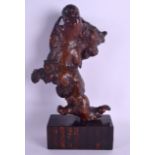 A 19TH CENTURY CHINESE CARVED ROOTWOOD FIGURE OF AN IMMORTAL with fabulous patina, upon a banded