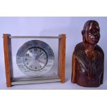 A CARVED AFRICAN WOODEN BUST, together with a world mantel clock. Figure 26 cm.