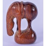 A MID 20TH CENTURY JAPANESE WOODEN NETSUKE IN THE FORM OF A HORSE, carved standing with its head
