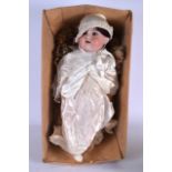 AN ANTIQUE PORCELAIN DOLL, together with two other smaller dolls. Largest 60 cm.