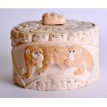 A 19TH CENTURY JAPANESE MEIJI PERIOD CARVED IVORY TUSK BOX AND COVER decorated with mask heads and
