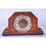 AN EARLY 20TH CENTURY ROSEWOOD MANTEL CLOCK, with carved geometric support. 23.5 cm wide.