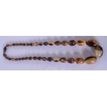 AN EARLY 20TH CENTURY CHINESE CARVED BUFFALO HORN BEAD NECKLACE. Total length 60 cm, largest bead