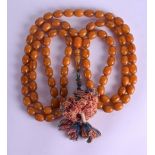 A VERY LONG 19TH CENTURY CHINESE TIBETAN AMBER PRAYER COURT NECKLACE with hanging silk work