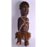 A LARGE EARLY 20TH CENTURY AFRICAN TRIBAL CARVED WOODEN FIGURE inlaid with circular motifs. 64 cm