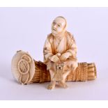 A SMALL 19TH CENTURY JAPANESE MEIJI PERIOD CARVED IVORY OKIMONO modelled as a male seated upon logs.