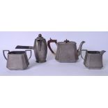 AN ART DECO HAMMERED PEWTER TEA SET, comprising of tea pot, coffee pot, sugar bowl and milk jug. Tea