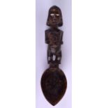 AN EARLY 20TH CENTURY AFRICAN TRIBAL CARVED SPOON modelled holding her stomach with bone eyes. 24 cm