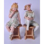 A LARGE PAIR OF GERMAN BISQUE FIGURES, in the form of children seated upon octagonal plinths. 42