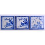 A SET OF THREE 19TH CENTURY JAPANESE BLUE AND WHITE TILES painted with game birds within landscapes.