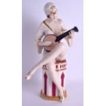 A LARGE ART DECO AUSTRIAN ROYAL DUX FIGURE OF A SEMI CLAD MUSICIAN modelled playing an instrument