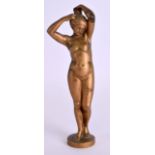 AN ART NOUVEAU GILT BRONZE FIGURE OF A NUDE FEMALE modelled with arms raised upon a circular base.