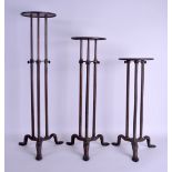A GOOD SET OF THREE FINLAY OF LONDON INDUSTRIAL ADJUSTABLE BRONZE STANDS with circular tops and