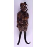 A 19TH CENTURY BAVARIAN CARVED BLACK FOREST FOX COAT HOOK modelled wearing a hunting jacket. 30 cm