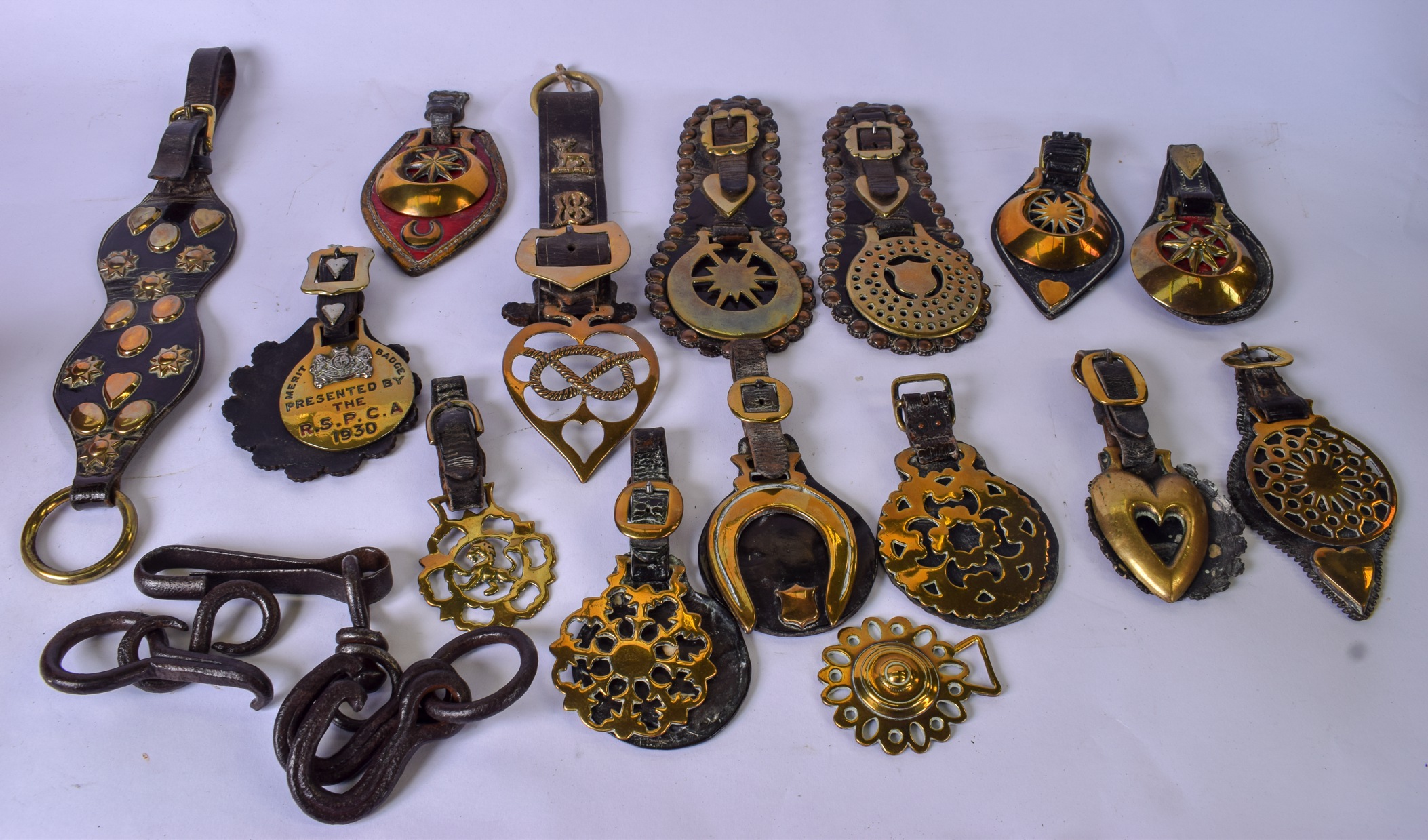 A GOOD COLLECTION OF ANTIQUE HORSE BRASSES AND OTHER ARTICLES, including a "Merit Badge" by the R.