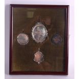 A SET OF FOUR MID 19TH CENTURY FRAMED SILVER MEDALLIONS with presentation inscriptions. (4)