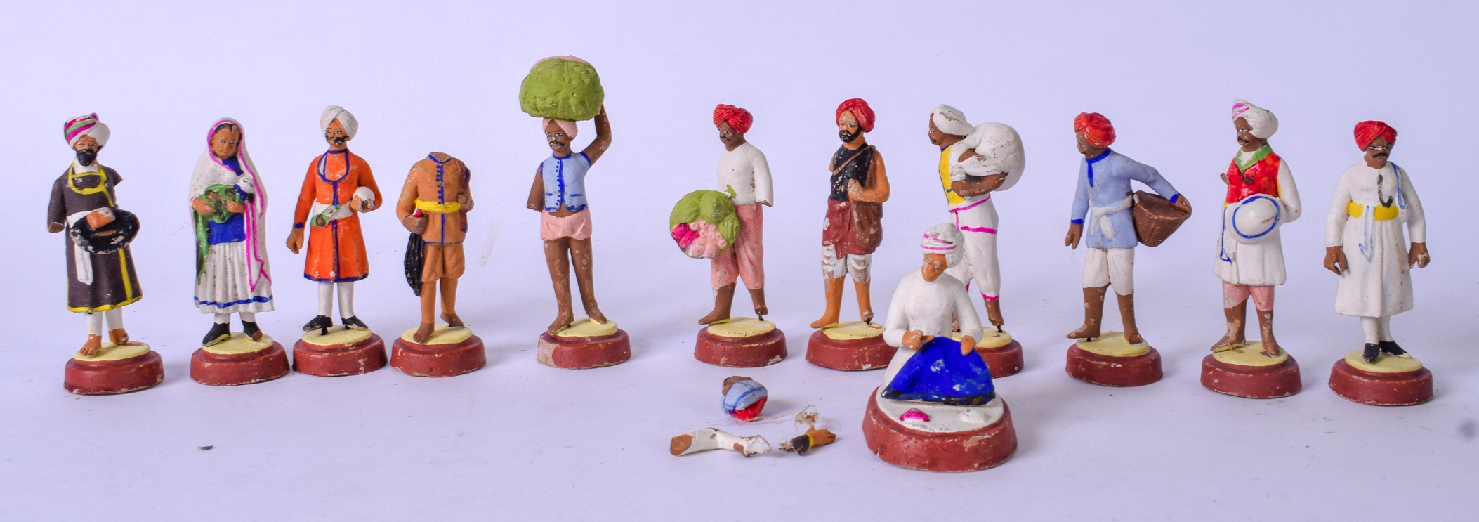 CIRCLE OF BHAWANI DAS, a set of twelve Indian terracotta company school figures, mostly trades