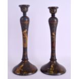 A PAIR OF MID 19TH CENTURY PERSIAN LACQUERED QAJAR CANDLESTICKS painted with figures in various