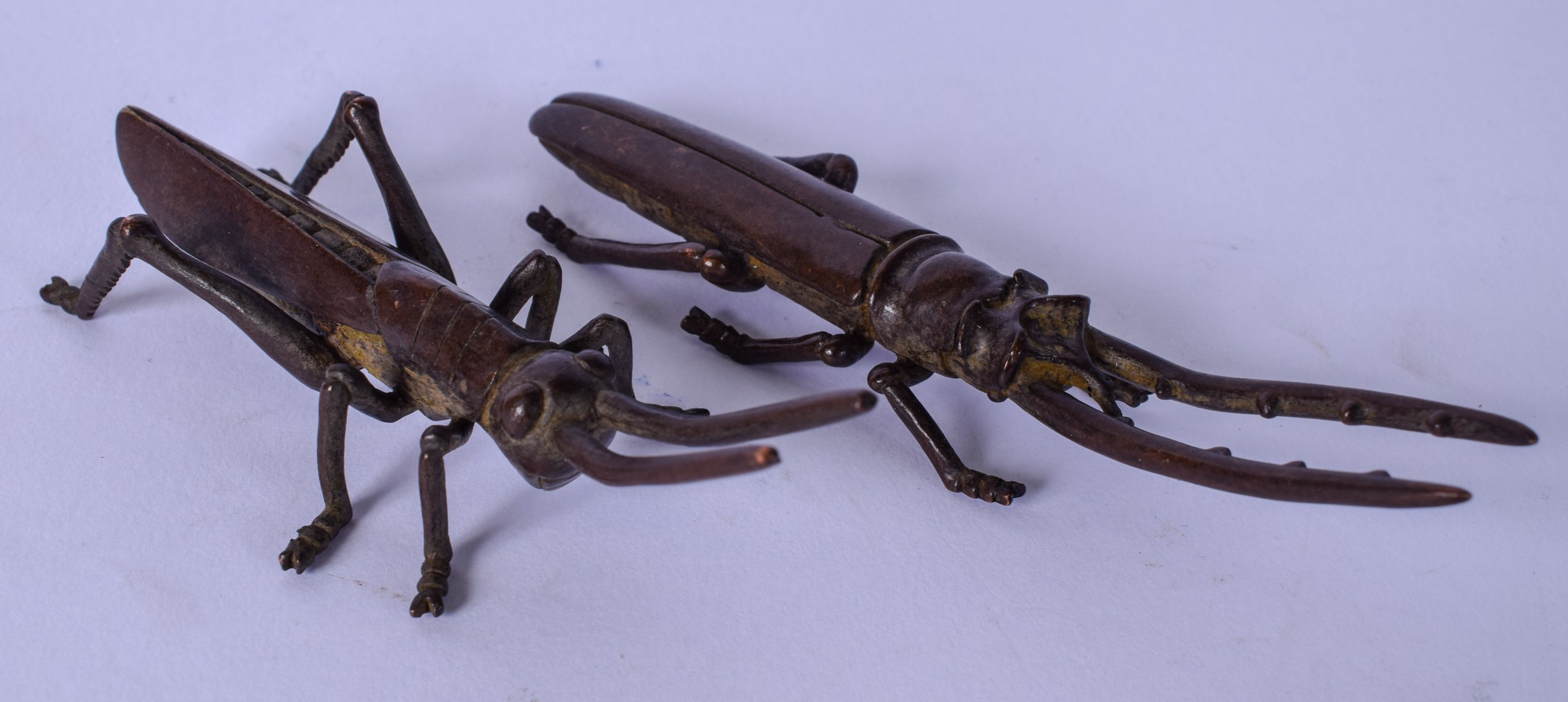 A JAPANESE TASIHO PERIOD BRONZE GRASS HOPPER, together with a beetle. 12.5 cm and 11.5 cm.