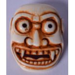 A GOOD 19TH CENTURY JAPANESE EDO / MEIJI PERIOD IVORY NOH MASK BUCKLE, in the form of a grinning