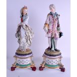 A LARGE PAIR OF EARLY 20TH CENTURY BISQUE FIGURES, formed as a standing female in a hood and a