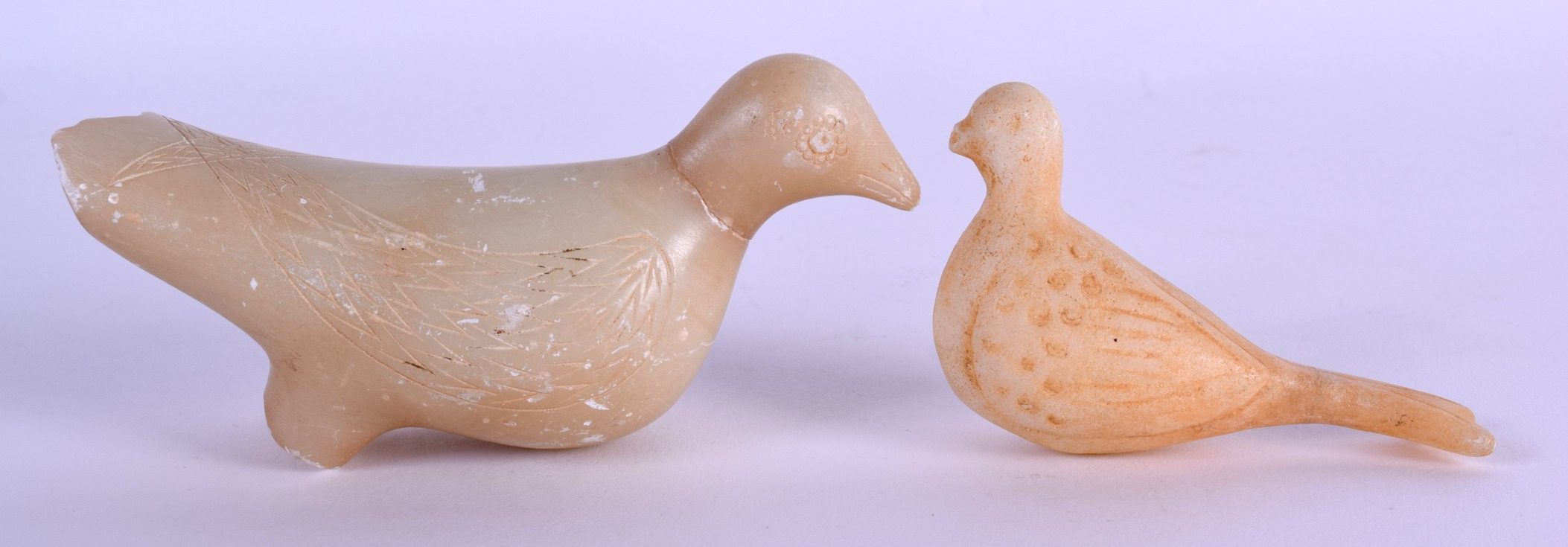 TWO 18TH/19TH CENTURY CENTRAL ASIAN CARVED STONE BIRDS with incised features. 12 cm & 9 cm wide. (