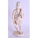 A LATE 19TH CENTURY JAPANESE MEIJI PERIOD CARVED IVORY OKIMONO modelled as a roaming male holding an