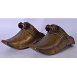 A LARGE PAIR OF EASTERN BRONZE SHOES, engraved with foliate inspired design. 26 cm long.