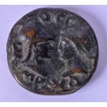 A BRONZE COIN, decorated with opposing heads. 5.8 cm.