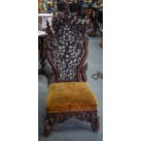 A GOOD 19TH CENTURY BURMESE HARDWOOD CHAIR, carved with dragons and foliage. 120 cm high.