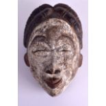 A LARGE EARLY 20TH CENTURY AFRICAN TRIBAL CARVED POLYCHROMED WOOD MASK modelled as a female with