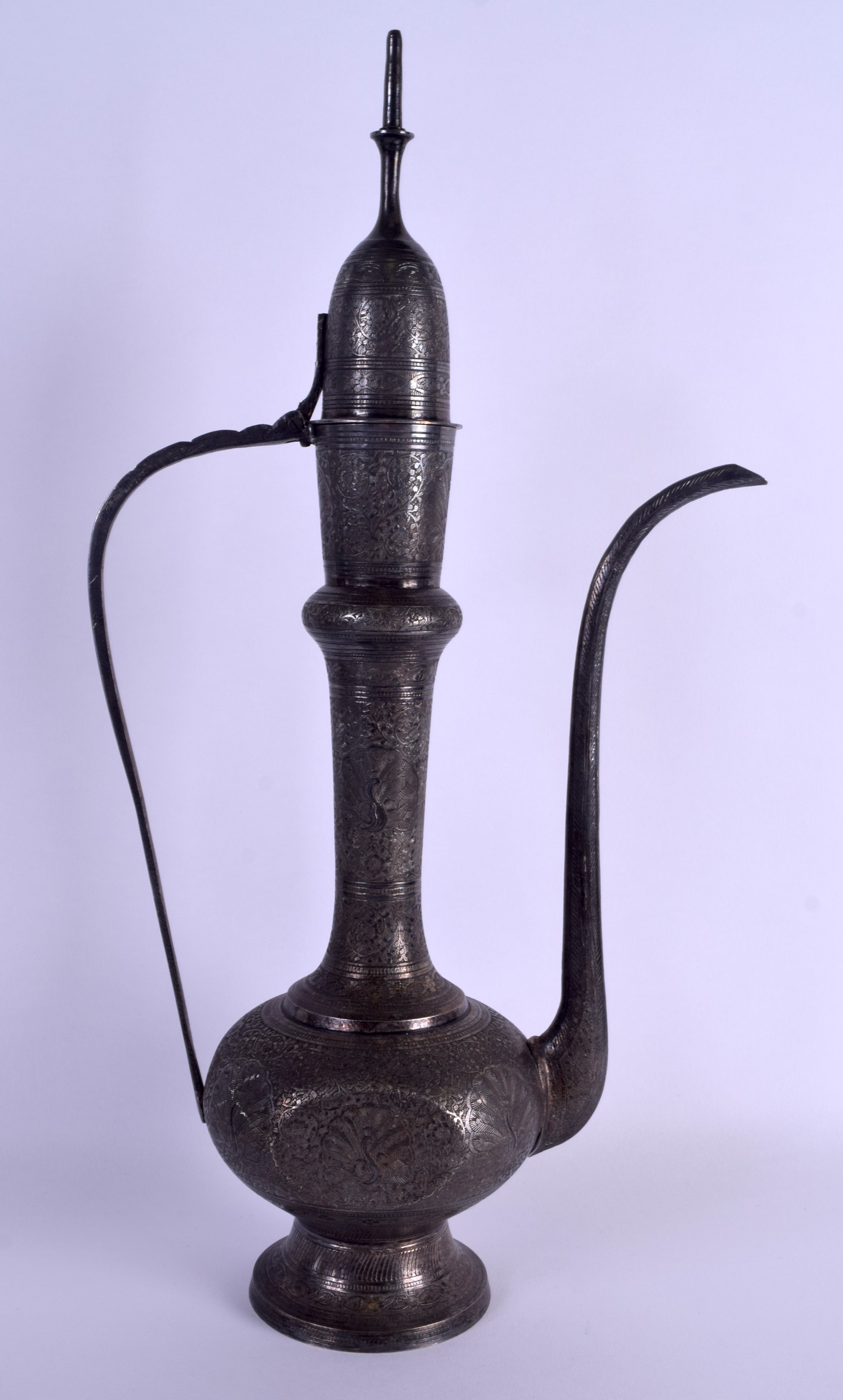 A LARGE 19TH CENTURY MIDDLE EASTERN TINNED WHITE METAL EWER decorated with script, foliage and