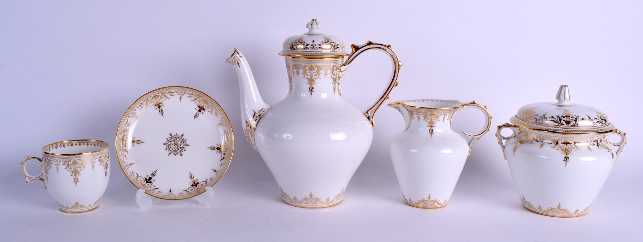 A GOOD CASED 19TH CENTURY FRENCH SEVRES PORCELAIN TEASET painted with rich gilt scrolling foliage. - Image 2 of 8