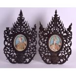 A PAIR OF 19TH CENTURY INDIAN PAINTED IVORY PORTRAIT MINIATURES contained within carved hardwood