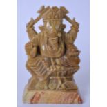 AN EARLY 20TH CENTURY INDIAN SOAPSTONE STATUE OF GANESHA, carved seated upon a throne. 12.5 cm