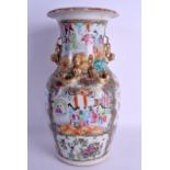 A 19TH CENTURY CHINESE CANTON FAMILLE ROSE VASE painted with figures within landscapes. 36 cm x 17