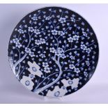 A LARGE 19TH CENTURY JAPANESE BLUE AND WHITE PORCELAIN CHARGER painted with flowering prunus. 40