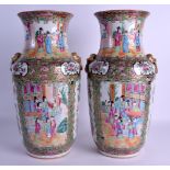 A PAIR OF 19TH CENTURY CHINESE CANTON FAMILLE ROSE VASES Qing, painted with figures and butterflies.