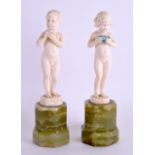 A FINE PAIR OF ART DECO CARVED IVORY FIGURES OF A BOY AND GIRL by Ferdinand Preiss, modelled nude
