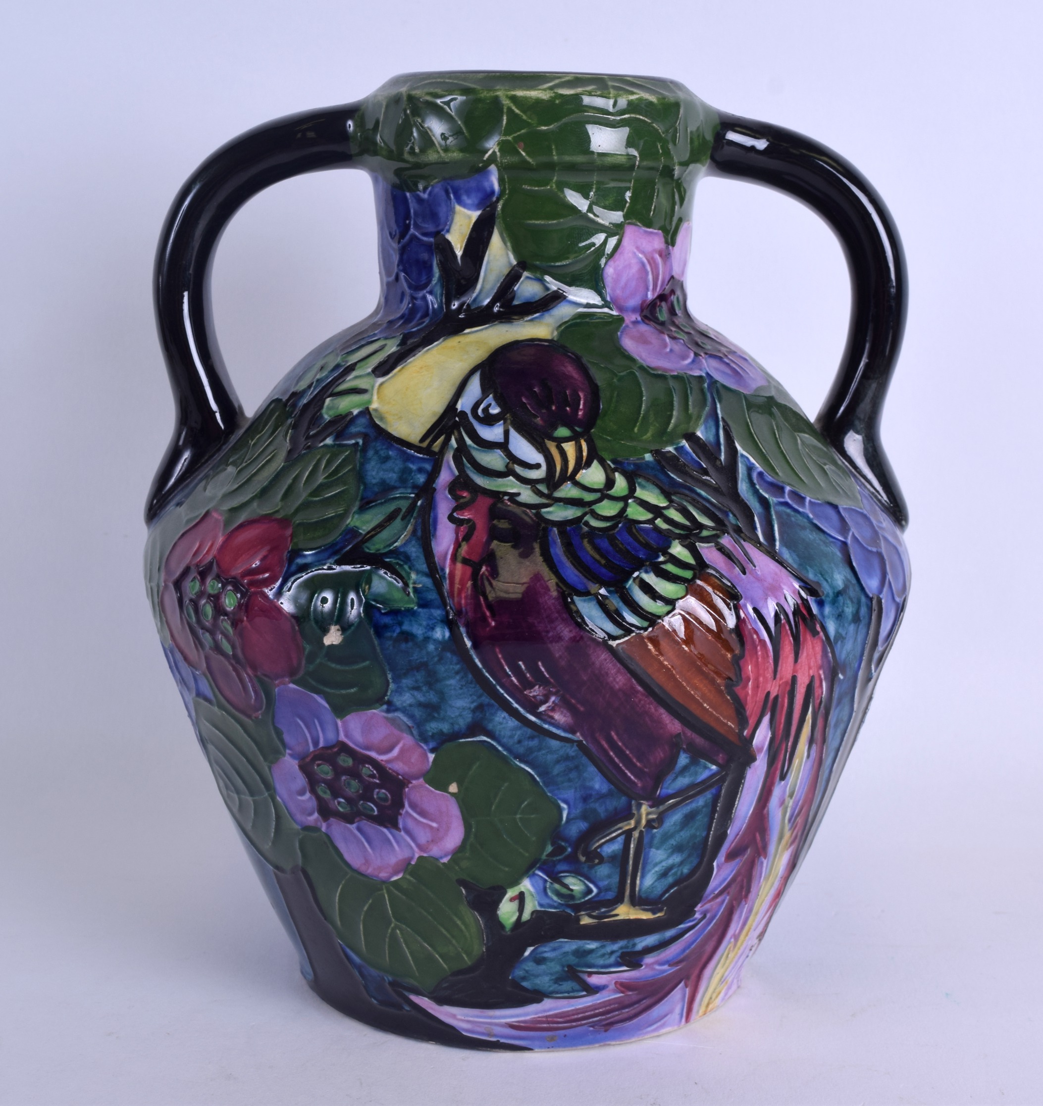 AN UNUSUAL TUBE LINED TWIN HANDLED TROGON WARE VASE decorated with a parrot amongst foliage. 22 cm x