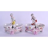 A PAIR OF 19TH CENTURY KPM BERLIN PORCELAIN FIGURAL TABLE SALTS painted with figures within