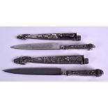 A PAIR OF EARLY 20TH CENTURY CONTINENTAL SILVER DAGGERS with embossed scabbards, decorated with