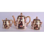 A 19TH CENTURY DAVENPORT IMARI THREE PIECE TEASET painted with flowers. Teapot 16 cm wide. (3)