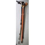 A GROUP OF FIVE ASSORTED WALKING CANES including a brass dog head cane and novelty golf cane. (5)