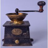 AN EARLY 20TH CENTURY COFFEE GRINDER, iron body, with turned wooden handle. 19 cm high.