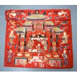 A 19TH CENTURY CHINESE RED EMBROIDERED SILK PANEL depicting figures and a child dancing within a